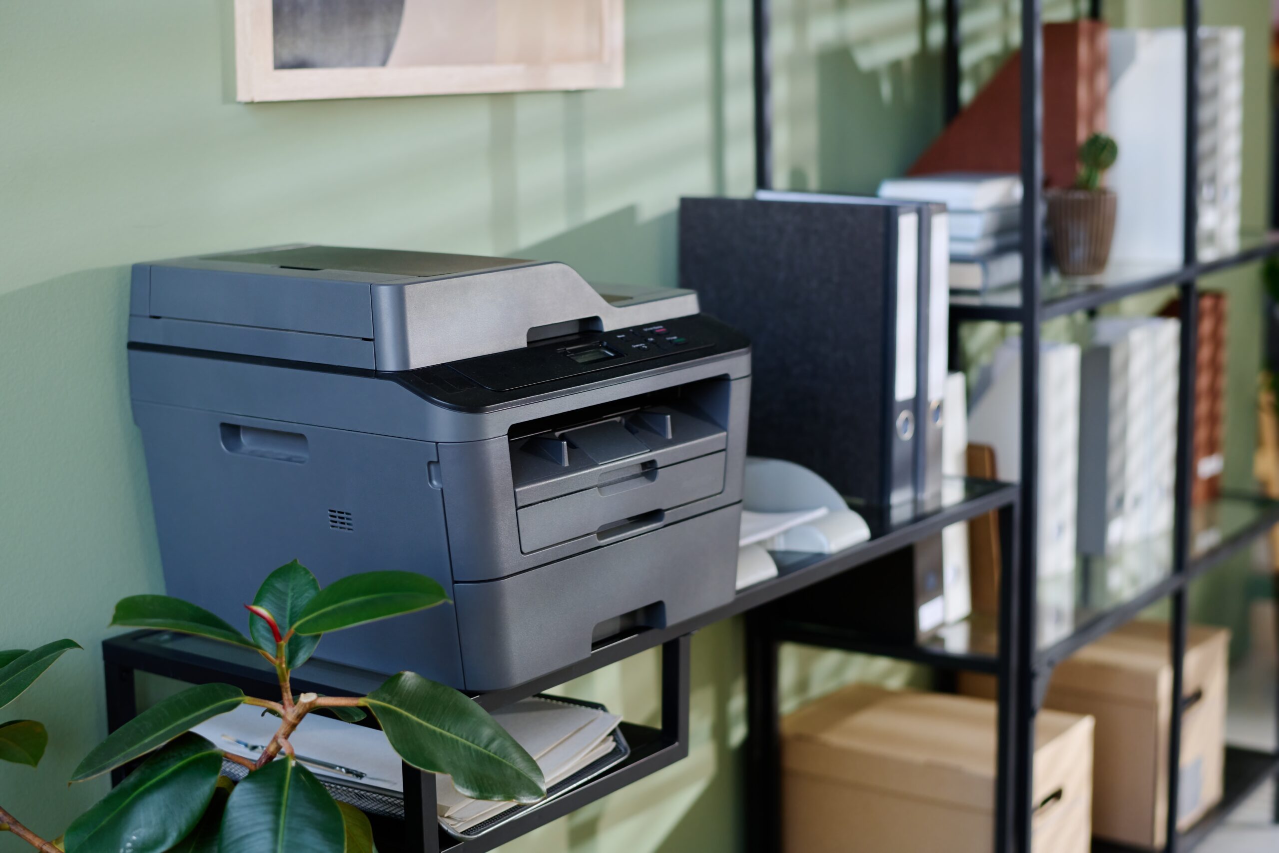 Multifunction,Printer,Standing,On,Office,Shelf,Surrounded,By,Green,Plant,